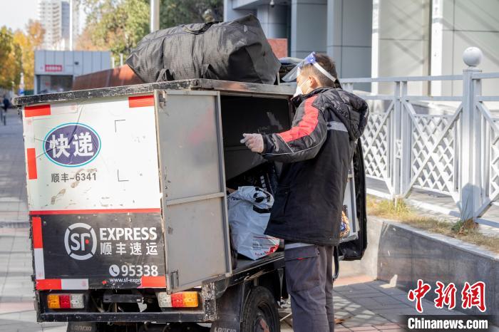 图为快递小哥整理货物。　程航 摄