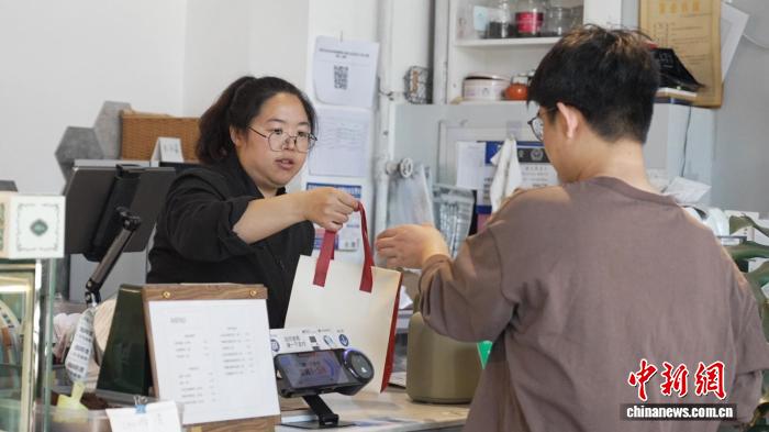 潘姵蓉在位于乌鲁木齐的甜品店里工作。胡嘉琛 摄