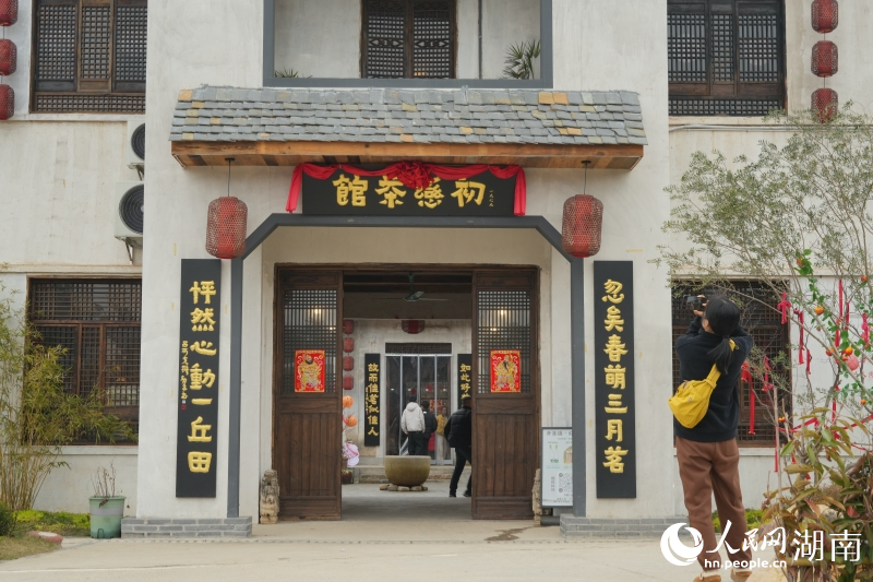 游客在茶馆前拍照留念。人民网记者 刘汕摄